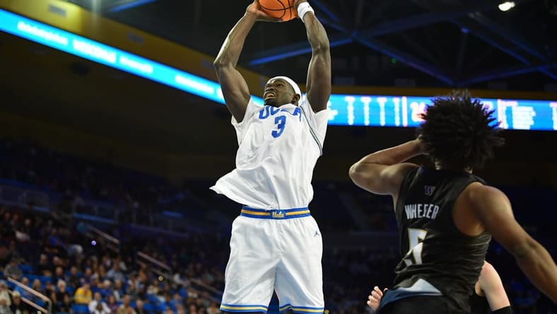 January 14, 2024; Los Angeles, California, USA; UCLA Bruins forward Adem Bona (3) moves to the basket against Washington Huskies guard Sahvir Wheeler (5) during the second half at Pauley Pavilion. Mandatory Credit: Gary A. Vasquez-USA TODAY Sports
