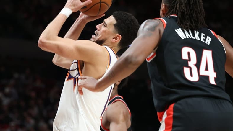 Jan 14, 2024; Portland, Oregon, USA; Phoenix Suns guard Devin Booker (1) shoots the ball over Portland Trail Blazers forward Jabari Walker (34) in the third quarter at Moda Center. Mandatory Credit: Jaime Valdez-USA TODAY Sports