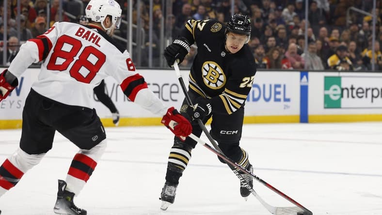 Jan 15, 2024; Boston, Massachusetts, USA; New Jersey Devils defenseman Kevin Bahl (88) gets his stick on a shot by Boston Bruins defenseman Hampus Lindholm (27) during the first period at TD Garden. Mandatory Credit: Winslow Townson-USA TODAY Sports