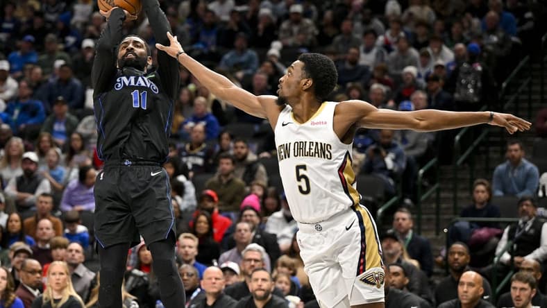 Jan 15, 2024; Dallas, Texas, USA; Dallas Mavericks guard Kyrie Irving (11) shoots the ball over New Orleans Pelicans forward Herbert Jones (5) during the second quarter at the American Airlines Center. Mandatory Credit: Jerome Miron-USA TODAY Sports