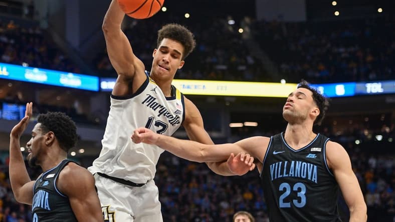 Jan 15, 2024; Milwaukee, Wisconsin, USA; Marquette Golden Eagles forward Oso Ighodaro (13) and Villanova Wildcats forward Tyler Burton (23) reach for a rebound in the second half at Fiserv Forum. Mandatory Credit: Benny Sieu-USA TODAY Sports