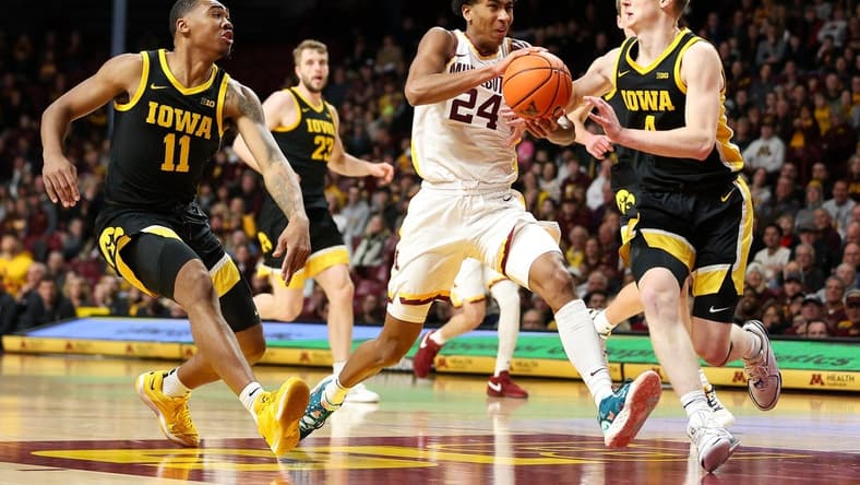 Jan 15, 2024; Minneapolis, Minnesota, USA; Minnesota Golden Gophers guard Cam Christie (24) works up court as Iowa Hawkeyes guard Josh Dix (4) and guard Tony Perkins (11) defend during the first half at Williams Arena. Mandatory Credit: Matt Krohn-USA TODAY Sports