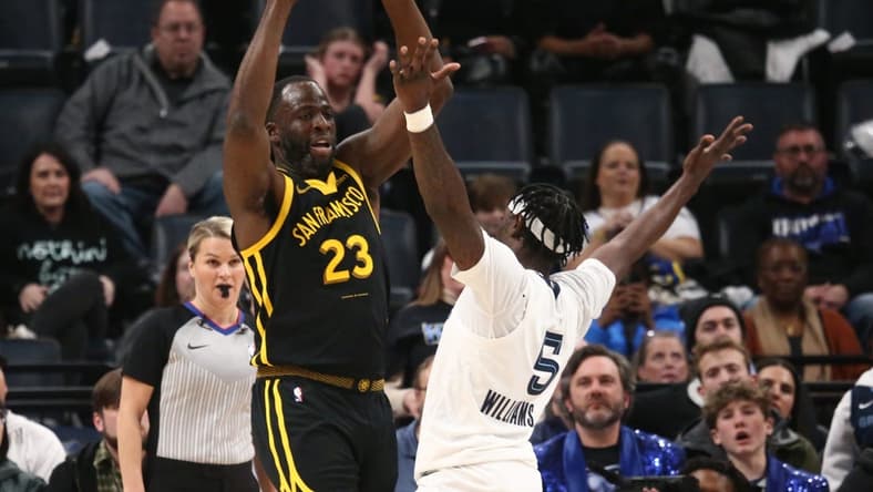 Jan 15, 2024; Memphis, Tennessee, USA; Golden State Warriors forward Draymond Green (23) passes the ball as Memphis Grizzlies guard Vince Williams Jr. (5) defends during the first half at FedExForum. Mandatory Credit: Petre Thomas-USA TODAY Sports