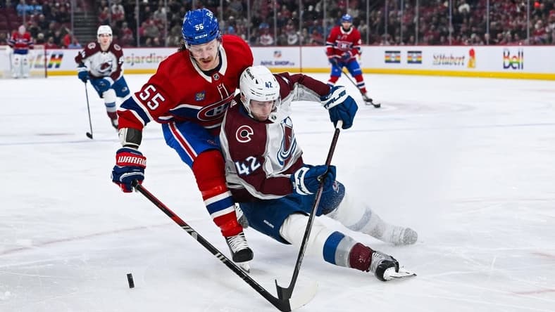 Jan 15, 2024; Montreal, Quebec, CAN; Colorado Avalanche defenseman Josh Manson (42) defends the puck against Montreal Canadiens left wing Michael Pezzetta (55) during the first period at Bell Centre. Mandatory Credit: David Kirouac-USA TODAY Sports
