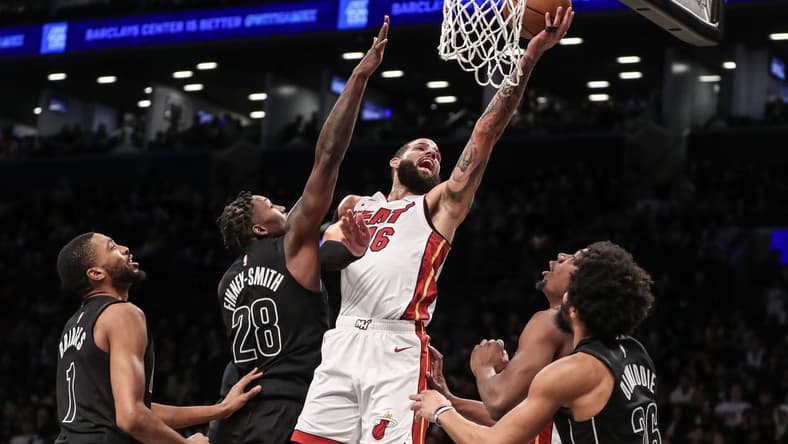 Jan 15, 2024; Brooklyn, New York, USA; Miami Heat forward Caleb Martin (16) drives past Brooklyn Nets forward Dorian Finney-Smith (28) for a layup in the second quarter at Barclays Center. Mandatory Credit: Wendell Cruz-USA TODAY Sports