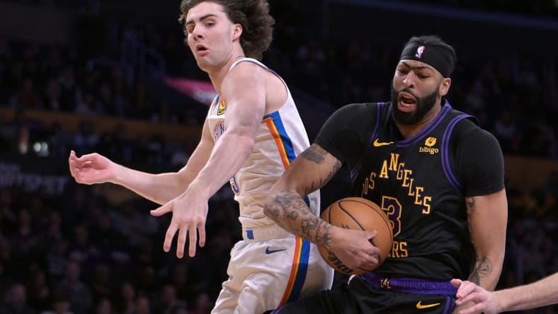 Jan 15, 2024; Los Angeles, California, USA;   Oklahoma City Thunder guard Josh Giddey (3) and Los Angeles Lakers forward Anthony Davis (3) go for a rebound in the first half at Crypto.com Arena. Mandatory Credit: Jayne Kamin-Oncea-USA TODAY Sports