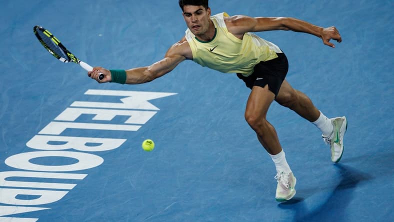 Jan 16, 2024; Melbourne, Victoria, Australia; Carlos Alcaraz of Spain hits a shot against Richard Gasquet of France in the first round of the men s singles at the Australian Open. Mandatory Credit: Mike Frey-USA TODAY Sports