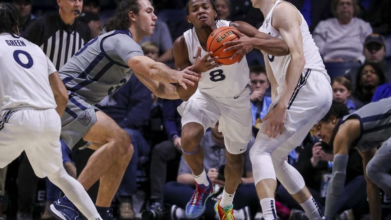 Jan 16, 2024; Cincinnati, Ohio, USA; Xavier Musketeers guard Quincy Olivari (8) dribbles against Butler Bulldogs forward Boden Kapke (33) in the first half at Cintas Center. Mandatory Credit: Katie Stratman-USA TODAY Sports
