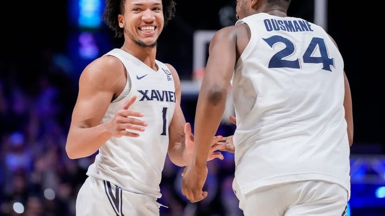 Xavier Musketeers guard Desmond Claude (1) and forward Abou Ousmane (24) celebrate a basket in the second half of the NCAA Big East basketball game between the Xavier Musketeers and the Butler Bulldogs at the Cintas Center in Cincinnati on Tuesday, Jan. 16, 2024. The Musketeers won 85-71.