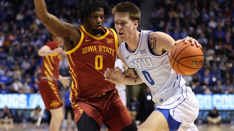 Jan 16, 2024; Provo, Utah, USA; Brigham Young Cougars forward Noah Waterman (0) drives to the basket against Iowa State Cyclones forward Tre King (0) during the first half at Marriott Center. Mandatory Credit: Rob Gray-USA TODAY Sports