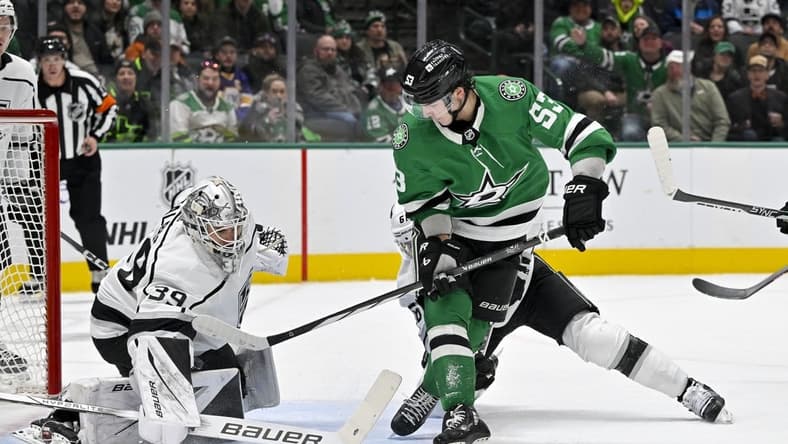 Jan 16, 2024; Dallas, Texas, USA; Los Angeles Kings goaltender Cam Talbot (39) stops a backhand shot by Dallas Stars center Wyatt Johnston (53) during the second period at the American Airlines Center. Mandatory Credit: Jerome Miron-USA TODAY Sports