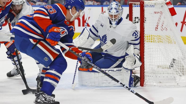 Jan 16, 2024; Edmonton, Alberta, CAN; Edmonton Oilers forward Ryan Nugent-Hopkins (93) takes a shot on Toronto Maple Leafs goaltender Martin Jones (31) during the first period at Rogers Place. Mandatory Credit: Perry Nelson-USA TODAY Sports