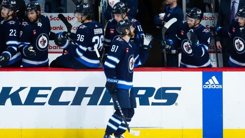 Jan 16, 2024; Winnipeg, Manitoba, CAN; Winnipeg Jets forward Kyle Connor (81) is congratulated by his teammates on his goal against the New York Islanders during the third period at Canada Life Centre. Mandatory Credit: Terrence Lee-USA TODAY Sports