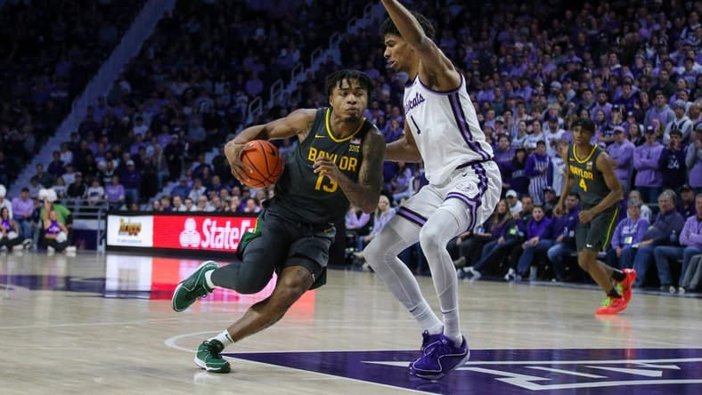 Jan 16, 2024; Manhattan, Kansas, USA; Baylor Bears guard Langston Love (13) dribbles against Kansas State Wildcats forward David N'Guessan (1) during the second half at Bramlage Coliseum. Mandatory Credit: Scott Sewell-USA TODAY Sports