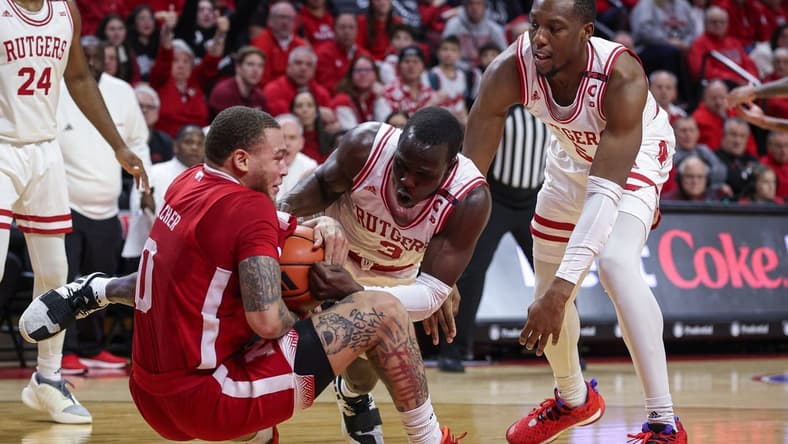 Jan 17, 2024; Piscataway, New Jersey, USA; Nebraska Cornhuskers guard C.J. Wilcher (0) and Rutgers Scarlet Knights forward Mawot Mag (3) battle for the ball in front of forward Aundre Hyatt (5) during the first half at Jersey Mike's Arena. Mandatory Credit: Vincent Carchietta-USA TODAY Sports