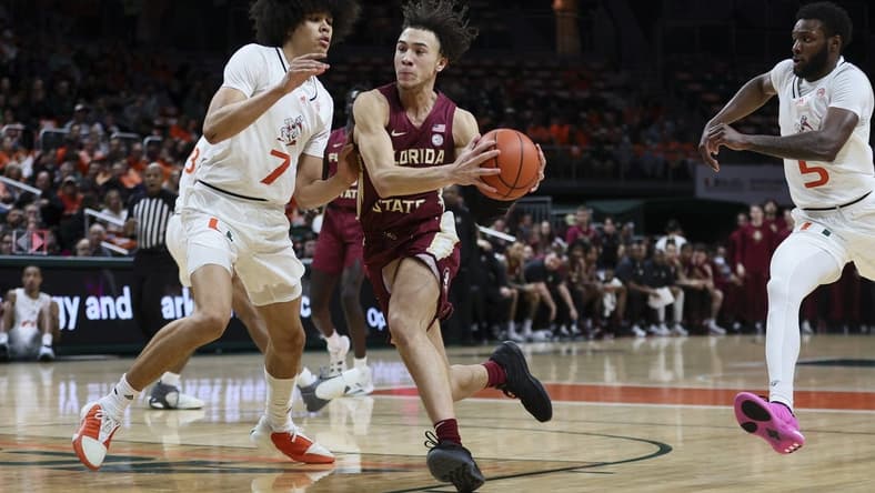 Jan 17, 2024; Coral Gables, Florida, USA; Florida State Seminoles guard Jalen Warley (1) drives to the basket against Miami Hurricanes guard Kyshawn George (7) during the first half at Watsco Center. Mandatory Credit: Sam Navarro-USA TODAY Sports