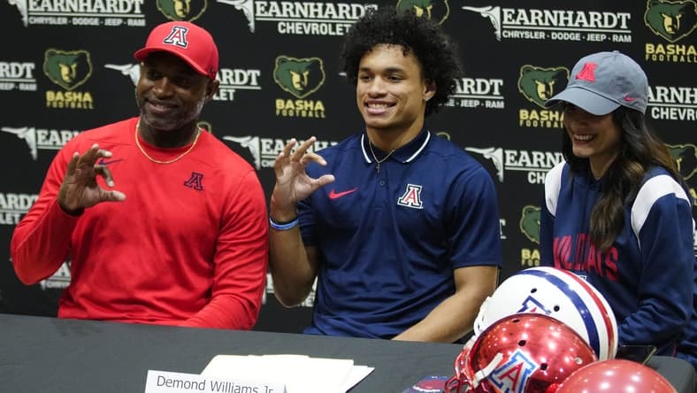 Basha quarterback Demond Williams poses for pictures after signing his letter of intent to play for University of Arizona during the NLI signing at Basha High School in Chandler on Dec. 20, 2023.