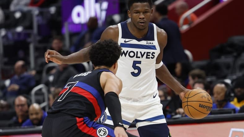 Jan 17, 2024; Detroit, Michigan, USA; Minnesota Timberwolves guard Anthony Edwards (5) dribbles defended by Detroit Pistons guard Killian Hayes (7) in the first half at Little Caesars Arena. Mandatory Credit: Rick Osentoski-USA TODAY Sports