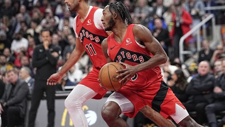 Jan 17, 2024; Toronto, Ontario, CAN; Toronto Raptors RJ Barrett (9)and Toronto Raptors forward Jontay Porter (11) head up court against Miami Heat during the first half at Scotiabank Arena. Mandatory Credit: John E. Sokolowski-USA TODAY Sports