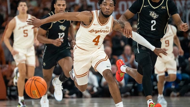 Texas Longhorns guard Tyrese Hunter (4) holds back UCF Knights guard Shemarri Allen (2) as they run after the ball during the game against University of Central Florida at the Moody center in Austin, Texas Wednesday, Jan. 17, 2023.