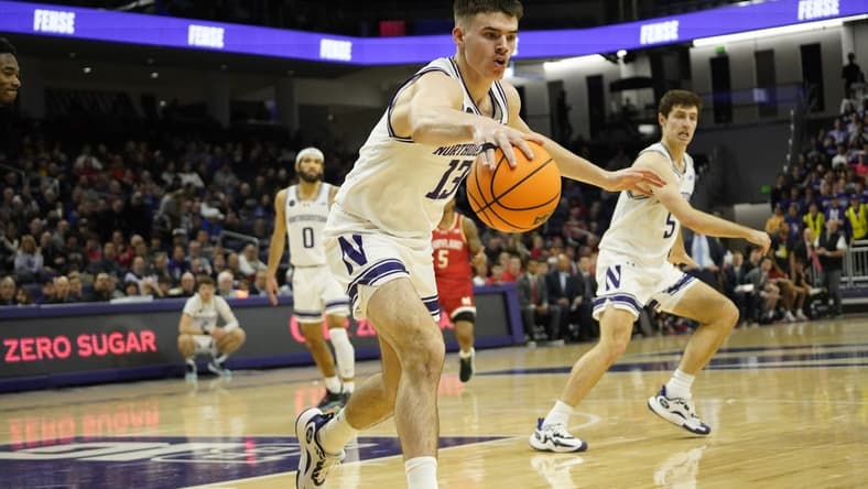 Jan 17, 2024; Evanston, Illinois, USA; Northwestern Wildcats guard Brooks Barnhizer (13) grabs a loose ball against the Maryland Terrapins during the first half at Welsh-Ryan Arena. Mandatory Credit: David Banks-USA TODAY Sports