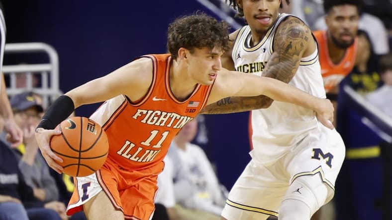 Jan 18, 2024; Ann Arbor, Michigan, USA; Illinois Fighting Illini guard Niccolo Moretti (11) dribbles the ball while Michigan Wolverines guard Dug McDaniel (0) defends in the first half at Crisler Center. Mandatory Credit: Rick Osentoski-USA TODAY Sports