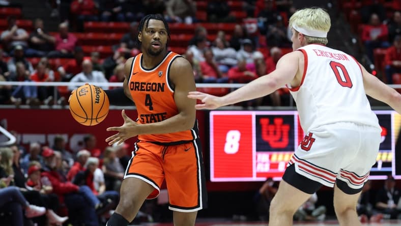 Jan 18, 2024; Salt Lake City, Utah, USA; Oregon State Beavers guard Dexter Akanno (4) looks to pass the ball on Utah Utes guard Hunter Erickson (0) during the first half at Jon M. Huntsman Center. Mandatory Credit: Rob Gray-USA TODAY Sports