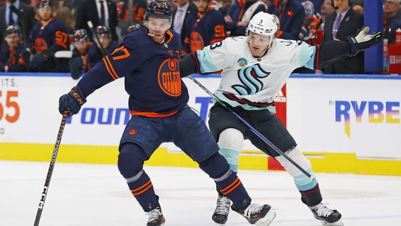 Jan 18, 2024; Edmonton, Alberta, CAN; Seattle Kraken defensemen Will Borgen (3) tries to pull Edmonton Oilers forward Connor McDavid (97) off the puck during the first period at Rogers Place. Mandatory Credit: Perry Nelson-USA TODAY Sports