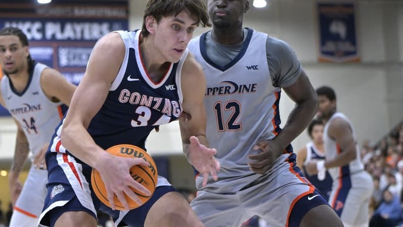 Jan 18, 2024; Malibu, California, USA; Gonzaga Bulldogs guard Luka Krajnovic (3) is defended by Pepperdine Waves forward Boubacar Coulibaly (12) in the first half at Firestone Fieldhouse. Mandatory Credit: Jayne Kamin-Oncea-USA TODAY Sports