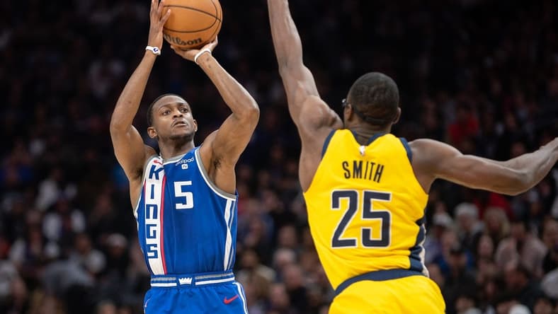 Jan 18, 2024; Sacramento, California, USA; Sacramento Kings guard De'Aaron Fox (5) takes a three point shot against Indiana Pacers forward Jalen Smith (25) during the second quarter at Golden 1 Center. Mandatory Credit: Ed Szczepanski-USA TODAY Sports