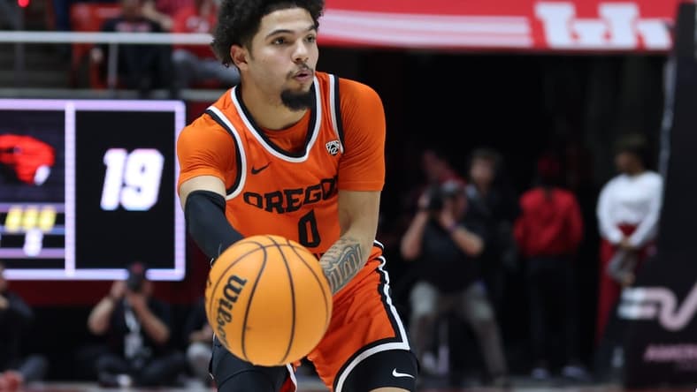 Jan 18, 2024; Salt Lake City, Utah, USA; Oregon State Beavers guard Jordan Pope (0) passes the ball against the Utah Utes during the first half at Jon M. Huntsman Center. Mandatory Credit: Rob Gray-USA TODAY Sports