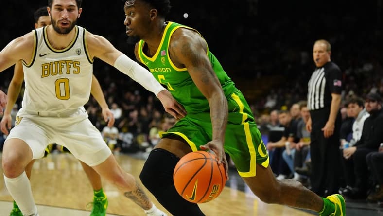 Jan 18, 2024; Boulder, Colorado, USA; Oregon Ducks guard Jermaine Couisnard (5) drives at Colorado Buffaloes guard Luke O'Brien (0) in the first half at the CU Events Center. Mandatory Credit: Ron Chenoy-USA TODAY Sports