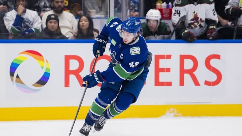 Jan 18, 2024; Vancouver, British Columbia, CAN; Vancouver Canucks defenseman Quinn Hughes (43) handles the puck against the Arizona Coyotes in the third period at Rogers Arena. Vancouver won 2-1. Mandatory Credit: Bob Frid-USA TODAY Sports
