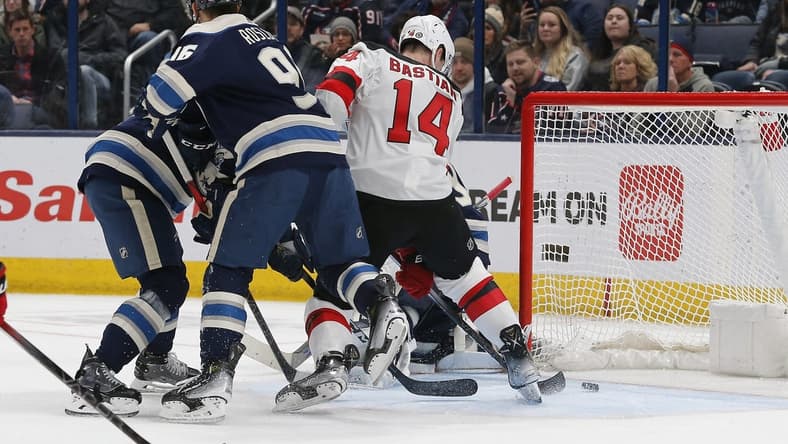 Jan 19, 2024; Columbus, Ohio, USA; New Jersey Devils right wing Nathan Bastian (14) tips the puck past Columbus Blue Jackets goalie Elvis Merzlikins (90) for a goal during the second period at Nationwide Arena. Mandatory Credit: Russell LaBounty-USA TODAY Sports