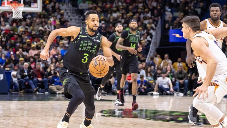 Jan 19, 2024; New Orleans, Louisiana, USA; New Orleans Pelicans guard CJ McCollum (3) dribbles against Phoenix Suns guard Grayson Allen (8) during the second half at Smoothie King Center. Mandatory Credit: Stephen Lew-USA TODAY Sports