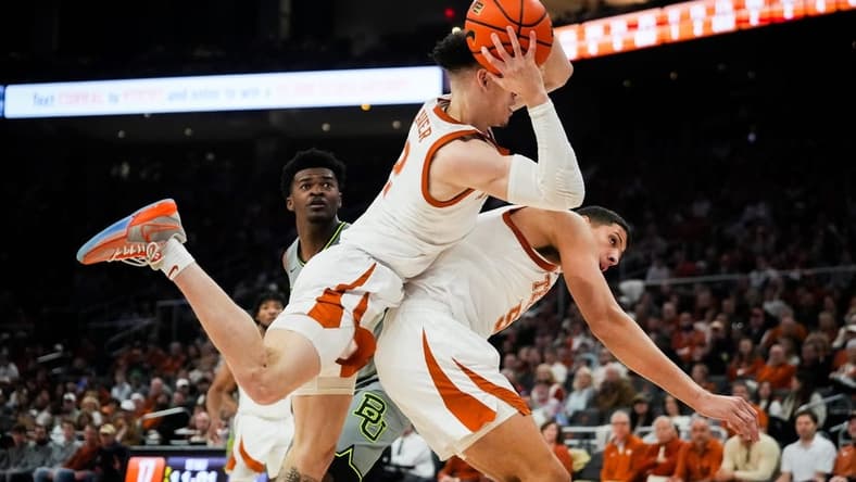 Texas Longhorns guard Chendall Weaver (2) lands on top of forward Kadin Shedrick (5) after catching a defensive rebound in the first half of the Longhorns   game against the Baylor Bears at the Moody Center in Austin, Jan 20, 2024.