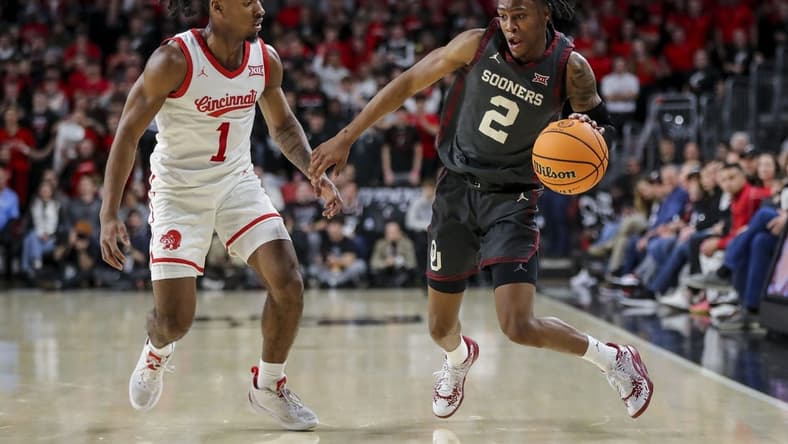 Jan 20, 2024; Cincinnati, Ohio, USA; Oklahoma Sooners guard Javian McCollum (2) dribbles against Cincinnati Bearcats guard Day Day Thomas (1) in the first half at Fifth Third Arena. Mandatory Credit: Katie Stratman-USA TODAY Sports