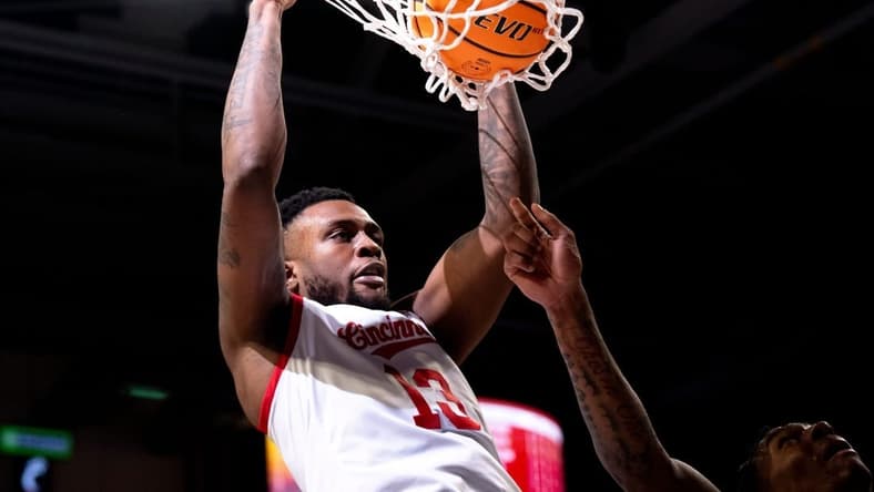 Cincinnati Bearcats forward Jamille Reynolds (13) dunks on Oklahoma Sooners forward Jalon Moore (14) in the first half of the NCAA basketball game between Cincinnati Bearcats and Oklahoma Sooners at Fifth Third Arena in Cincinnati on Saturday, Jan. 20, 2024.
