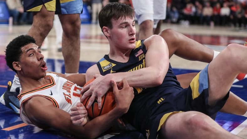 Jan 20, 2024; New York, New York, USA;  St. John's Red Storm guard RJ Luis Jr. (12) and Marquette Golden Eagles guard Tyler Kolek (11) fight for a loose ball in the second half at Madison Square Garden. Mandatory Credit: Wendell Cruz-USA TODAY Sports