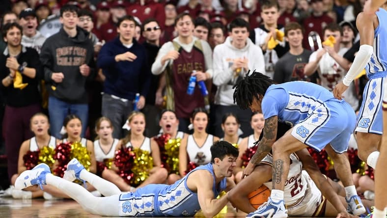 Jan 20, 2024; Chestnut Hill, Massachusetts, USA; North Carolina Tar Heels guard Cormac Ryan (3) and Boston College Eagles forward Devin McGlockton (21) battle for the ball during the first half at Conte Forum. Mandatory Credit: Eric Canha-USA TODAY Sports