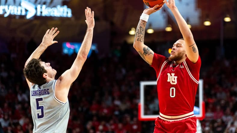 Jan 20, 2024; Lincoln, Nebraska, USA; Nebraska Cornhuskers guard C.J. Wilcher (0) shoots a three-point shot against Northwestern Wildcats guard Ryan Langborg (5) during the first half at Pinnacle Bank Arena. Mandatory Credit: Dylan Widger-USA TODAY Sports