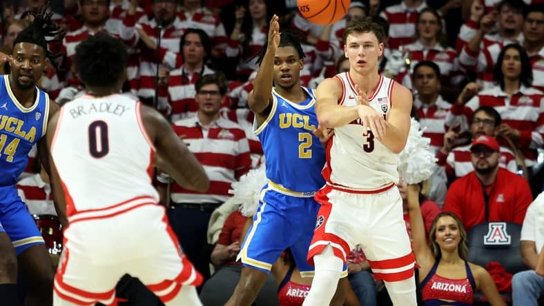 Jan 20, 2024; Tucson, Arizona, USA; Arizona Wildcats guard Pelle Larsson (3) makes a pass to guard Jaden Bradley (0) against UCLA Bruins guard Dylan Andrews (2) during the first half at McKale Center. Mandatory Credit: Zachary BonDurant-USA TODAY Sports