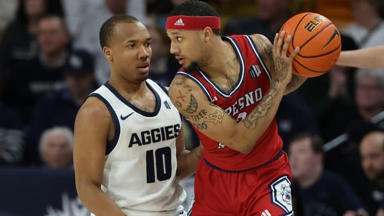 Jan 20, 2024; Logan, Utah, USA; Fresno State Bulldogs guard Isaiah Hill (3) looks to move the ball against Utah State Aggies guard Darius Brown II (10) during the first half at Dee Glen Smith Spectrum. Mandatory Credit: Rob Gray-USA TODAY Sports