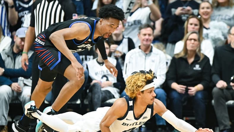Jan 20, 2024; Indianapolis, Indiana, USA;  Butler Bulldogs guard DJ Davis (4) dives for the ball in front of DePaul Blue Demons forward Jeremiah Oden (25) during the first half at Hinkle Fieldhouse. Mandatory Credit: Robert Goddin-USA TODAY Sports