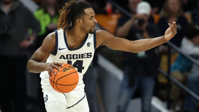 Jan 20, 2024; Logan, Utah, USA; Utah State Aggies guard Josh Uduje (14) calls a play against the Fresno State Bulldogs during the second half at Dee Glen Smith Spectrum. Mandatory Credit: Rob Gray-USA TODAY Sports