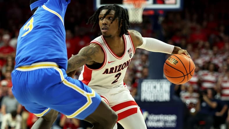 Jan 20, 2024; Tucson, Arizona, USA; Arizona Wildcats guard Caleb Love (2) dribbles the ball agaisnt UCLA Bruins forward Adem Bona (3) during the second half at McKale Center. Mandatory Credit: Zachary BonDurant-USA TODAY Sports