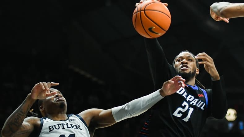 Jan 20, 2024; Indianapolis, Indiana, USA;  Butler Bulldogs guard Jahmyl Telfort (11) and DePaul Blue Demons forward Da'Sean Nelson (21) battle for a rebound during the second half at Hinkle Fieldhouse. Mandatory Credit: Robert Goddin-USA TODAY Sports