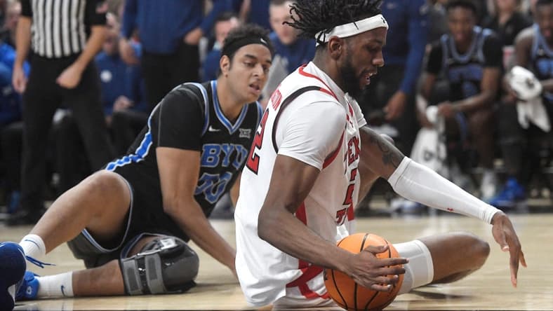 Texas Tech's forward Warren Washington (22) attempts to grab a loose ball against BYU in a Big 12 basketball game, Saturday, Jan. 20, 2024, at United Supermarkets Arena.
