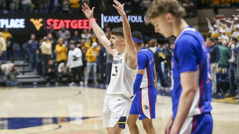 Jan 20, 2024; Morgantown, West Virginia, USA; West Virginia Mountaineers guard Kerr Kriisa (3) celebrates late in the second half against the Kansas Jayhawks at WVU Coliseum. Mandatory Credit: Ben Queen-USA TODAY Sports