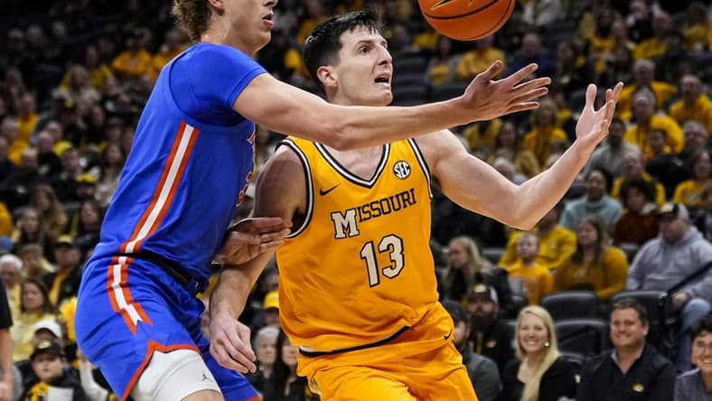 Jan 20, 2024; Columbia, Missouri, USA; Missouri Tigers forward Jesus Carralero Martin (13) loses control of the ball as he drives against Florida Gators center Micah Handlogten (3) during the first half at Mizzou Arena. Mandatory Credit: Jay Biggerstaff-USA TODAY Sports